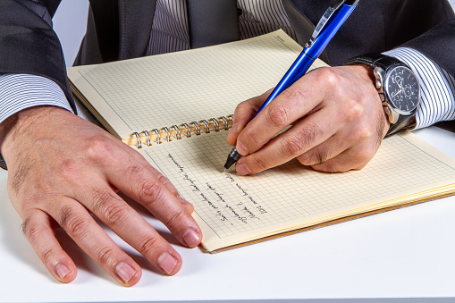 business man hands are on notebook and writing horizontal business still