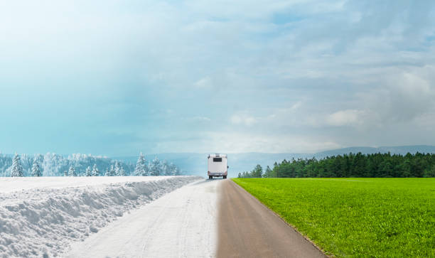 istock Camper on a road in winter with snow and in summer 1904521351