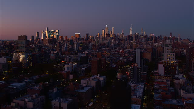 Midtown Manhattan and Hudson Yards at sunset. Distant wide-angle panoramic view over residential districts. Aerial footage with the static camera.