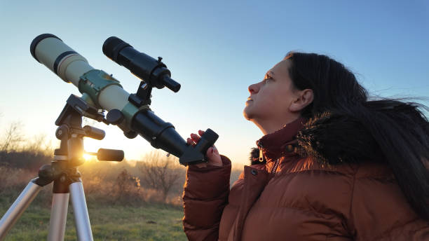 istock Amateur astronomer observing skies with a telescope. 1904549209