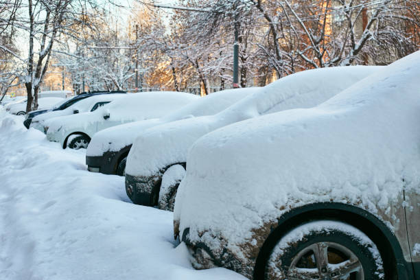 istock parked cars the road, snow-covered and uncleaned. 1904552066