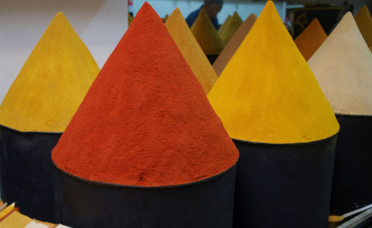 Cones of colourful spices for sale