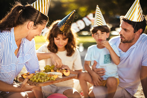 Family celebrates a birthday and has a party on the beach