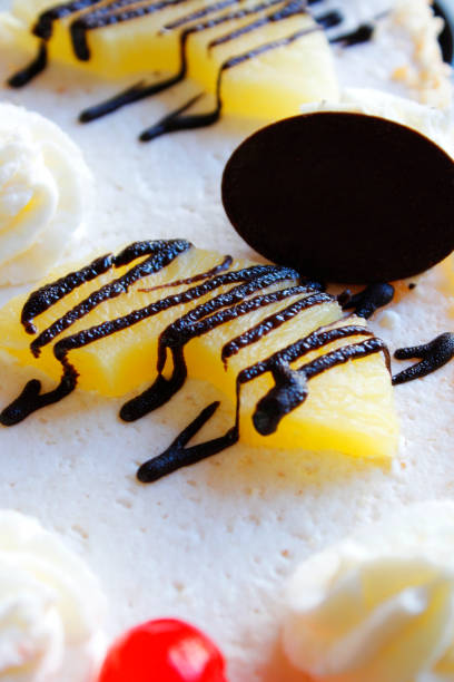 istock Detail of pineapple cake with chocolate and cherry 1904578524