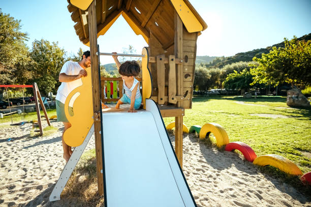 istock Happy boy sliding down in a playground 1904588017