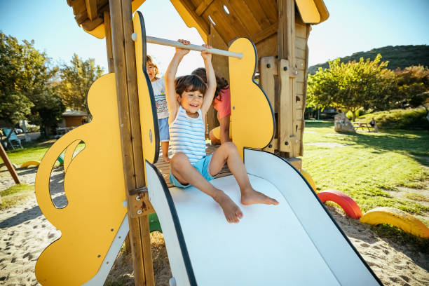 istock Happy boy sliding down in a playground 1904589038