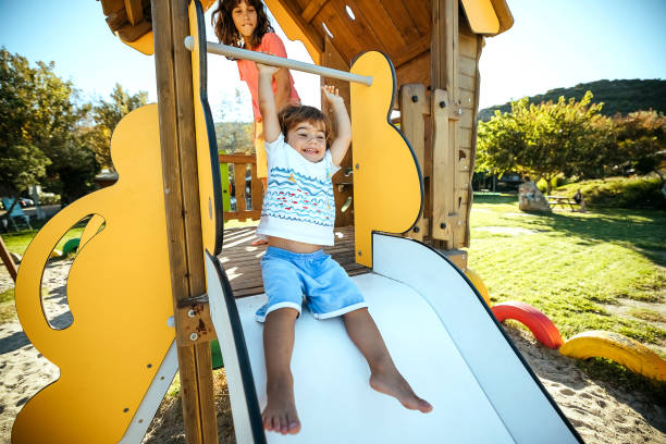 Deisgn of a wooden play house or treehouse with stairs and a slide