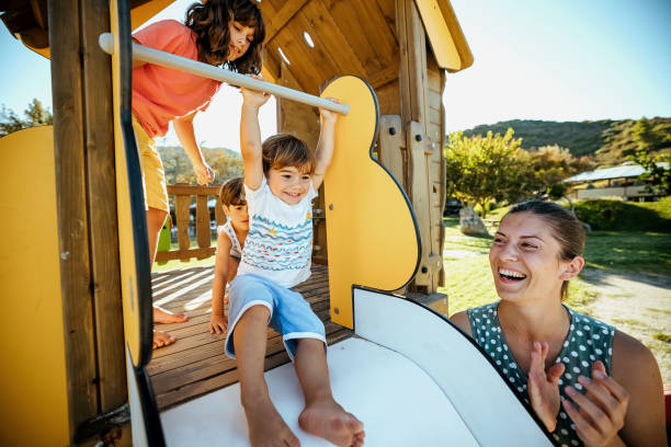 istock Happy boy sliding down in a playground 1904590079