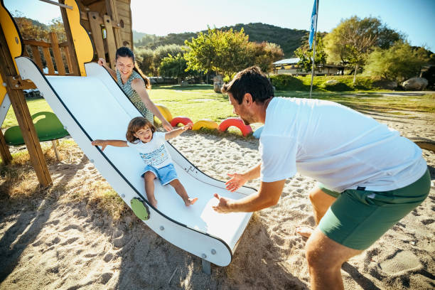 istock Happy boy sliding down in a playground 1904590082