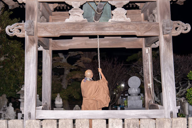 A monk ringing a bell to celebrate the new year