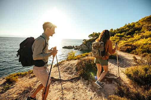 Couple man and woman hiking together outdoor travel lifestyle active summer vacation tourists