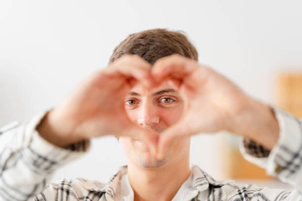 istock Face of a man gesturing love with hands 1904623075