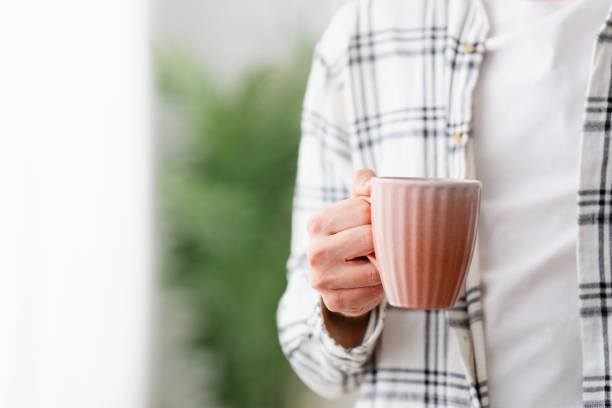 istock Close-up man holding a coffee cup at home 1904623592