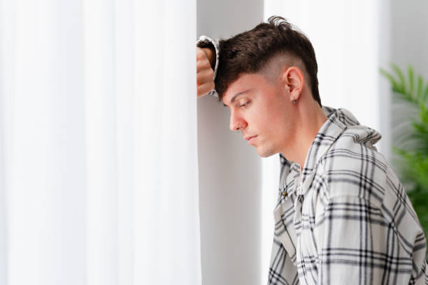 istock Teenager sad boy thinking beside window 1904624674