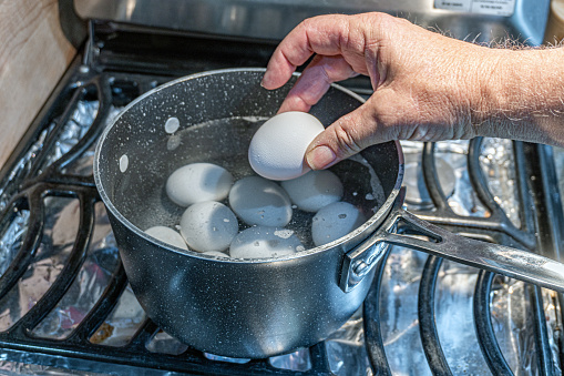 Boiling Eggs on a saucepan to make hard boiled eggs for Easter Eggs