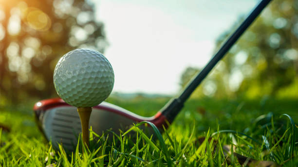 istock Golf ball and golf club in beautiful golf course at sunset background. 1904674812
