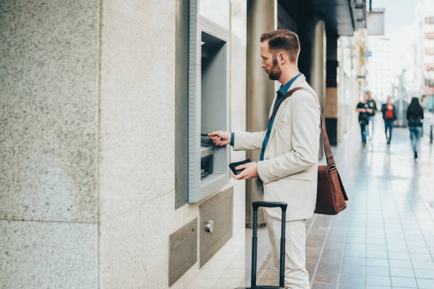 istock Businessman withdrawing money 1904704331