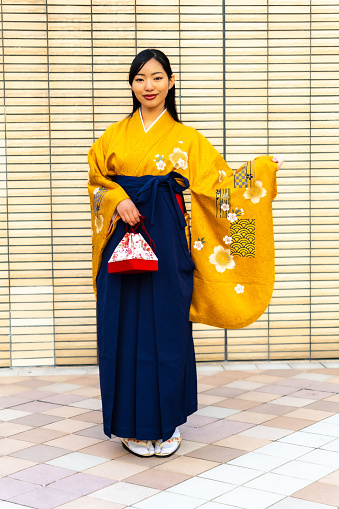 A woman in a hakama taking a commemorative photo