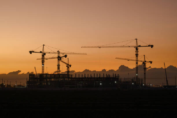 istock Silhouette of a building with backlit orange sky during sunset. 1904731849