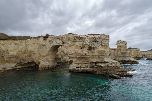 View of the Faraglioni of Torre Sant Andrea limestone sea stacks, Lecce province, Melendugno, Salento, Apulia, Italy