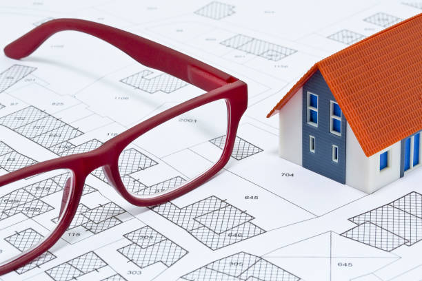 istock New home and free vacant land for building activity - Construction industry concept with a residential building with and imaginary cadastral map 1904762136