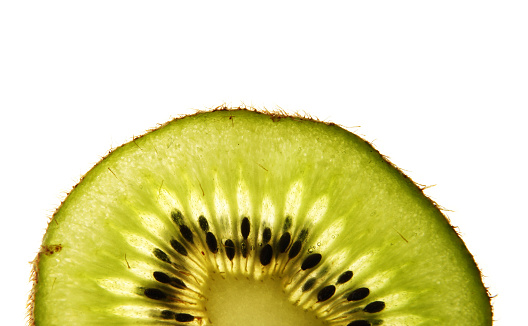Closeup slice of kiwi showing seeds and pulp