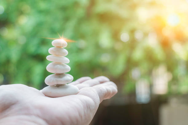 istock Build pebble stack on the sea shore on hand copy space and natural pebble stone beautiful. Concentration, balanced body, spirit, soul and relaxation concept. 1904787857