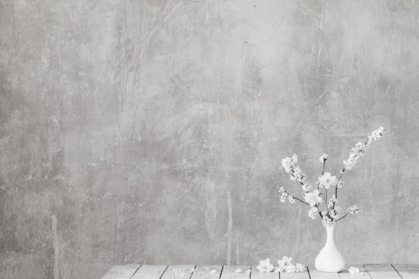 istock cherry flowers in white vase on background old gray wall 1904797000