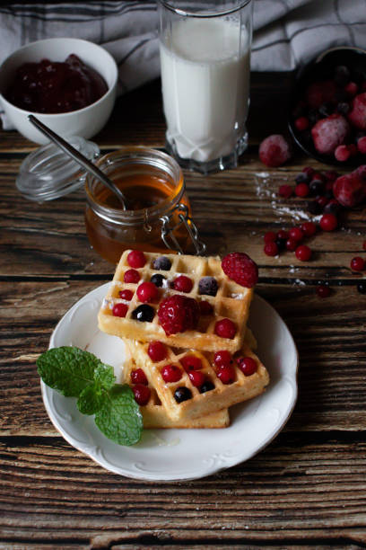 istock Hungarian waffles with berries on a wooden background. Breakfast. Dessert 1904801514