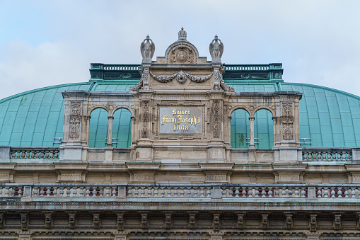 Vienna, Austria - 14 December 2023: gold inscription of emperor Francis Joseph on the pediment of the Vienna State Opera building