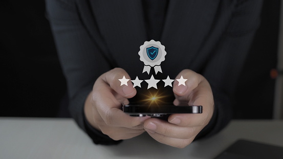 customer man hand pressing on smartphone screen with gold five star rating feedback icon and press level excellent rank for giving best score point to review the service