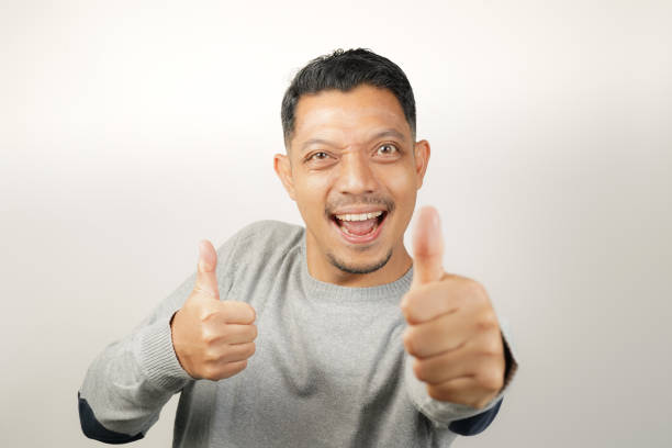 istock Cute happy face of handsome Asian man with thumbs up, steady expression 1904855884