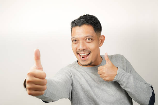 istock Cute happy face of handsome Asian man with thumbs up, steady expression 1904855893