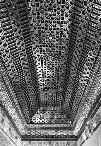 a largely symmetrical yet slightly asymmetrical brass ceiling