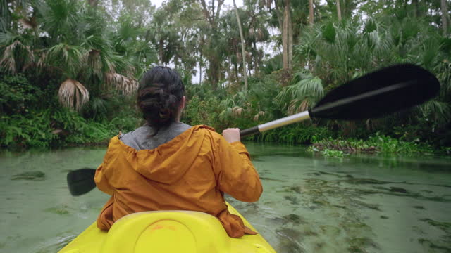 Lady Kayaking through a Jungle Spring River - Florida Freshwater River Springs