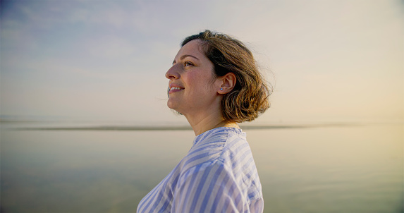 Woman standing on beach during vacation in sunny day.