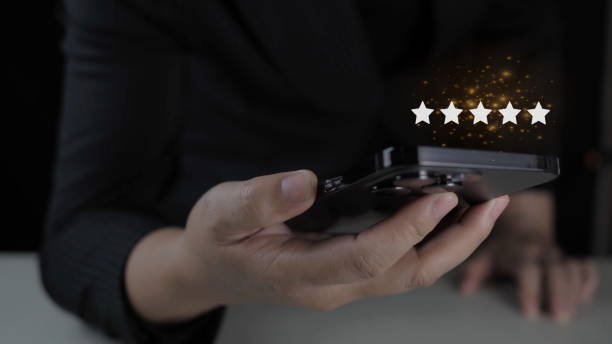 istock Businessman touches glowing yellow five-pointed star for excellent evaluation after customer uses ISO product service and global quality standards certification. 1904875482