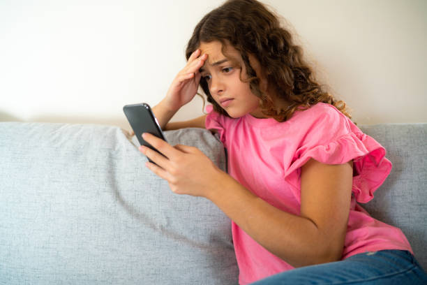 istock Worried girl using mobile phone at home 1904875525