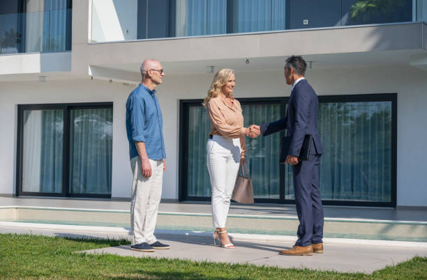 istock Real Estate Agent Shaking Hands With Property Buyers 1904888233