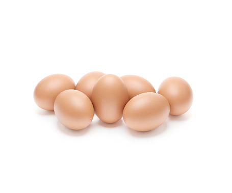 Pile of brown eggs isolated on white background.