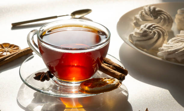 istock tea in a transparent mug or cup on a white, light background with marshmallow or meringue cakes,sweets breakfast or morning concept 1904897776