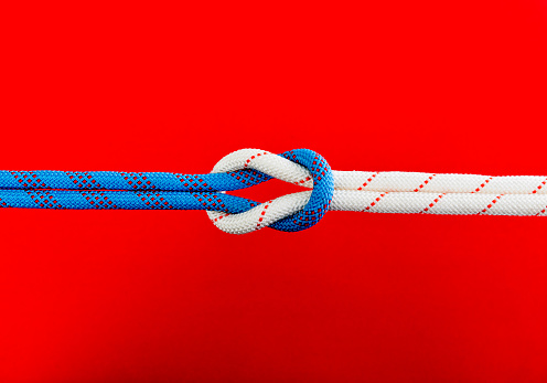 Reef knot on red background.