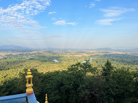 The temple is situated on a hill, providing visitors with breathtaking views of the surrounding Mae Chang valley.