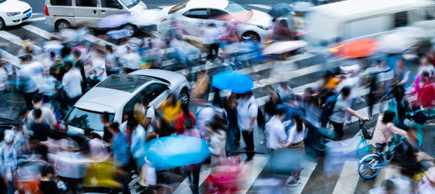 istock Motion blurred people and cars on the sidewalk 1904918679