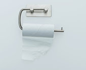 Empty toilet paper roll handing on white background