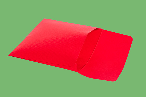 Rear view of an opened red gift envelope set against a green background, capturing the essence of Christmas greetings.
