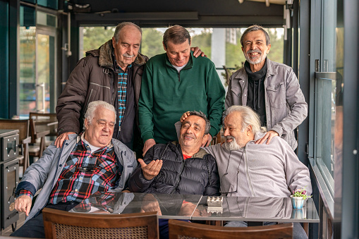 Coffee Meetup in Their 70s. Energetic 70-Year-Old Men Posing