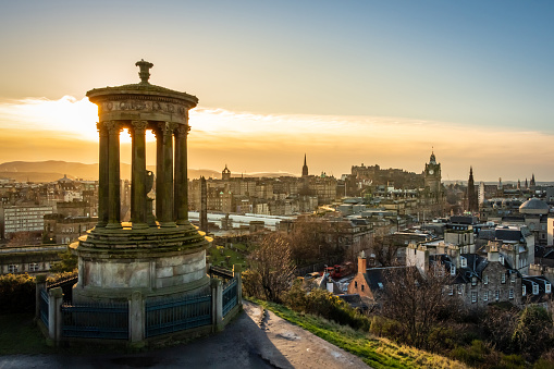 Sunset over Edinburgh from Calton Hill with old monument