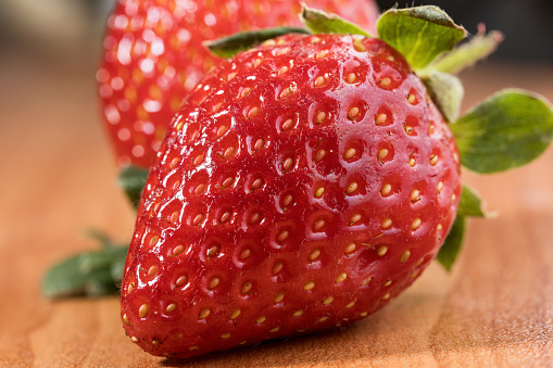 ripe very sweet strawberry berry photographed in close-up , macro photography , vitamins and health concept