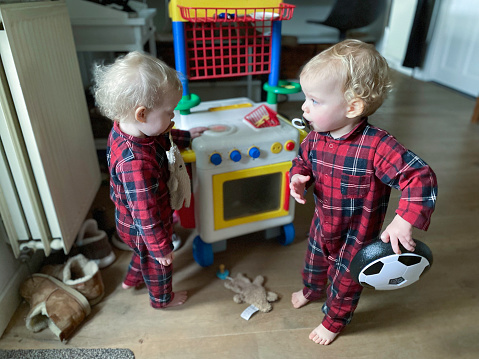 Toddler baby twin playing and eating together